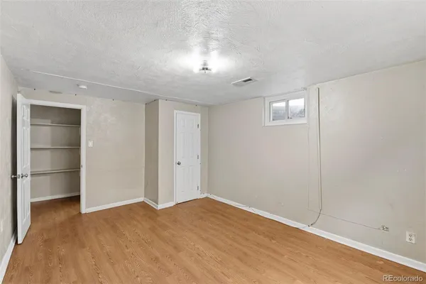 an empty room with a empty space and windows