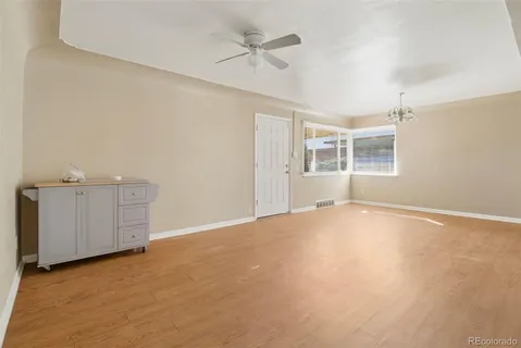 an empty room with a empty space and windows