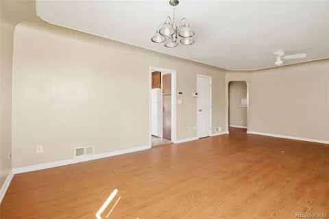 a view of an empty room with a chandelier