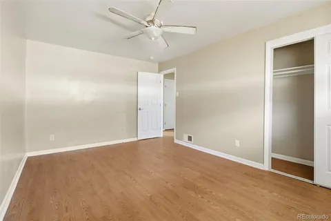 a view of an empty room with a ceiling fan