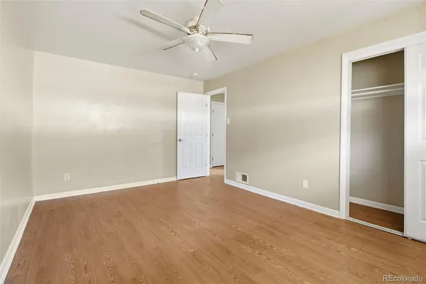 a view of an empty room with a ceiling fan
