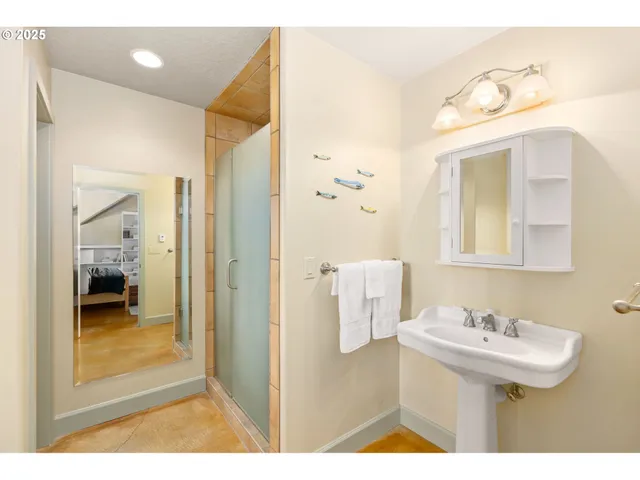 a bathroom with a sink a mirror and a shower