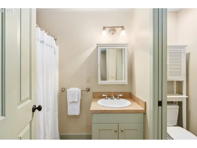 a bathroom with a sink vanity and a mirror