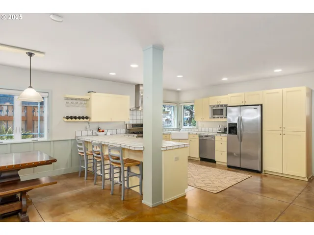 a kitchen with refrigerator and cabinets