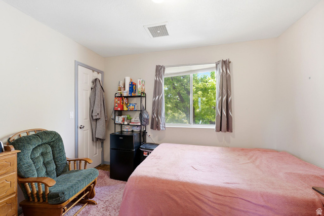 2475 Church Street Layton, UT 84040 - Photo 19 of 27 Room featuring a window with exterior tree views, white walls, and a white ceiling with a visible vent
