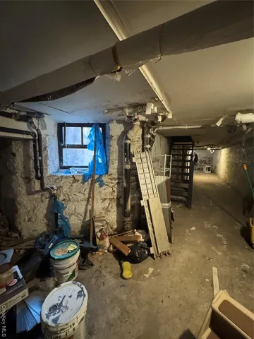 a storage room with water heater and racks