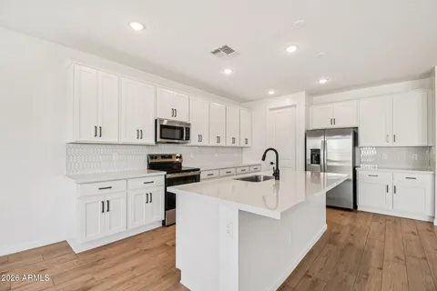 a view of a kitchen with cabinets and wooden floor