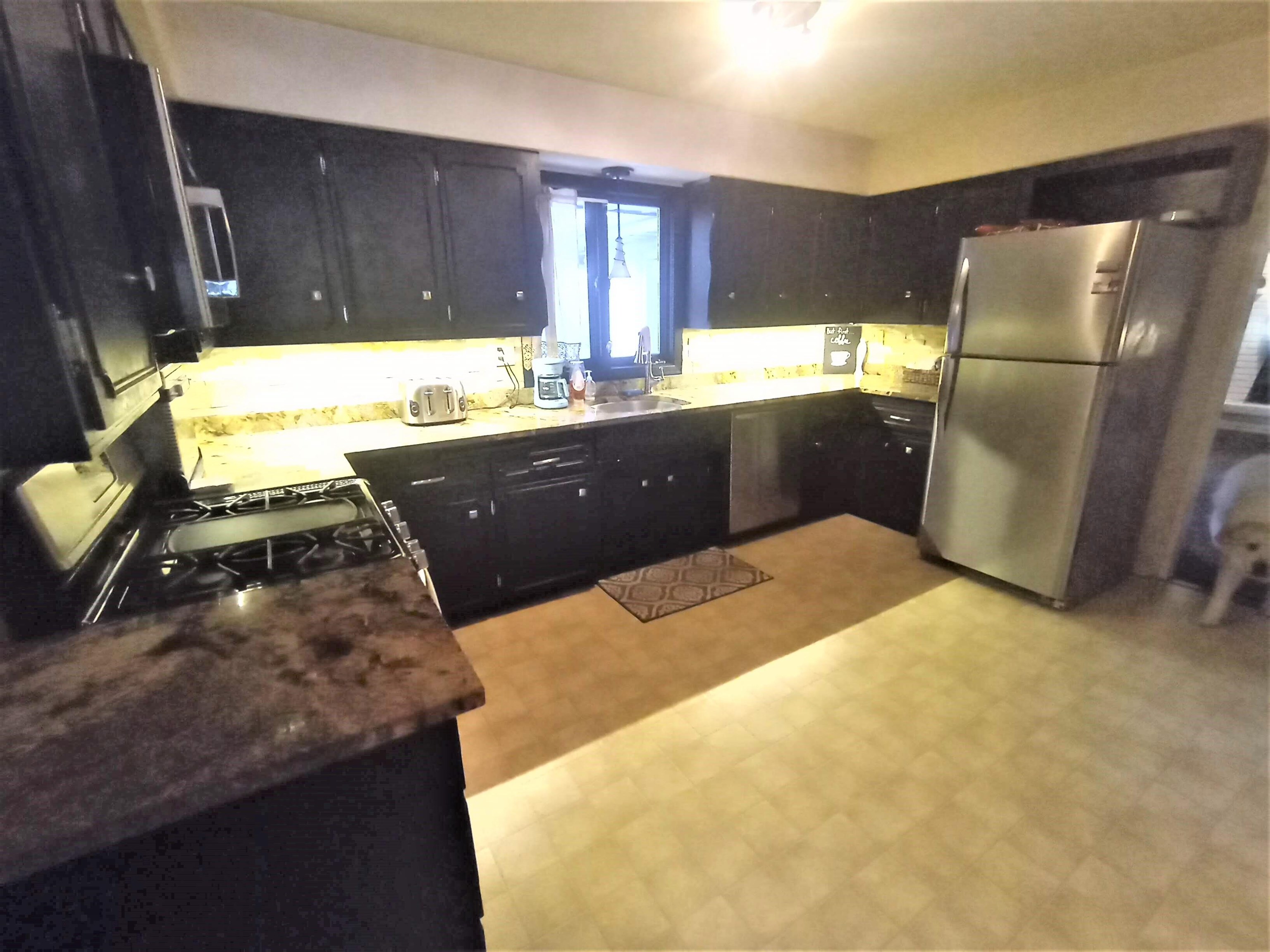 5242 Brookview Road Rockford, IL 61107 - Photo 11 of 44 a kitchen with a refrigerator and a stove top oven