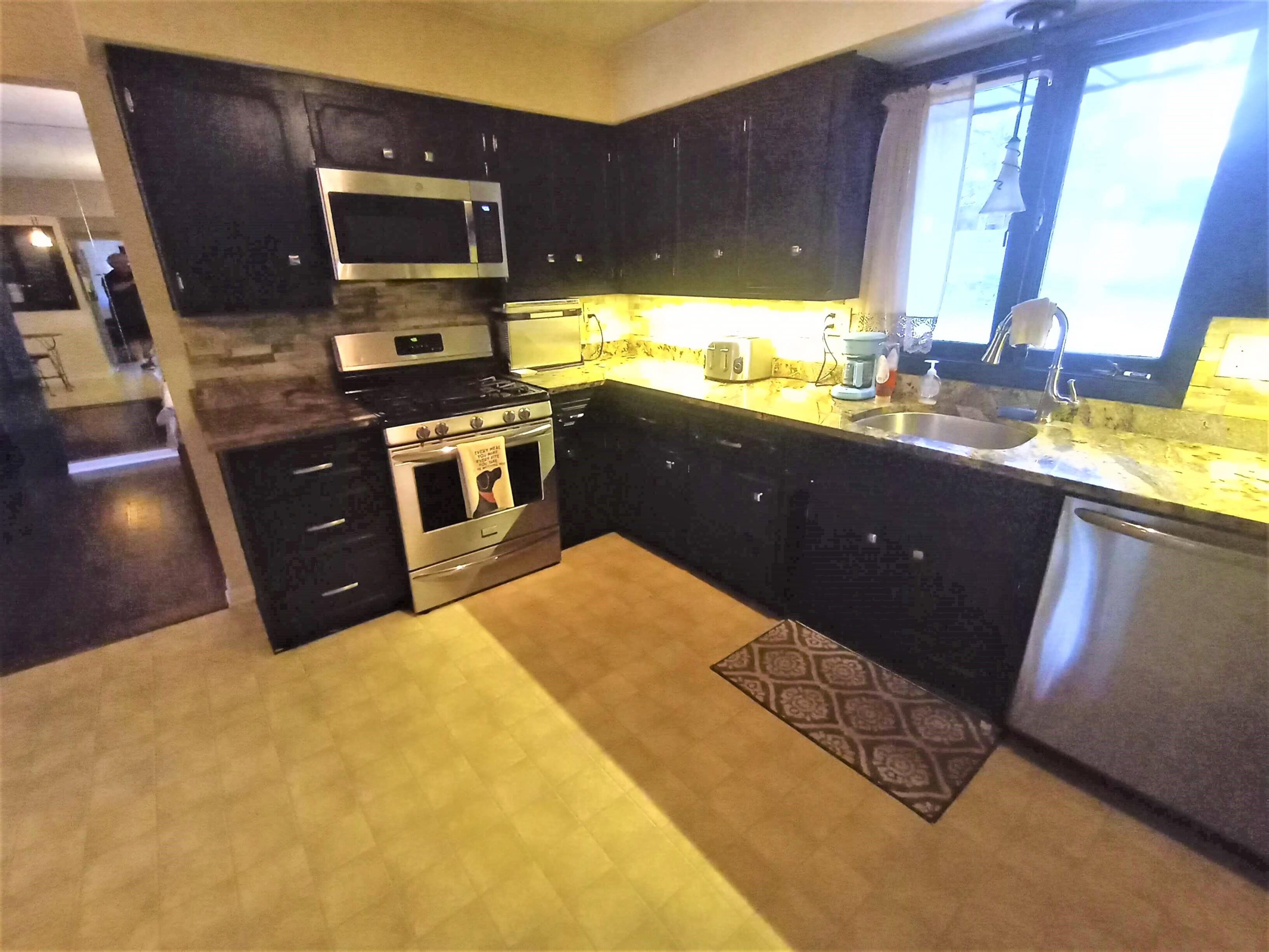 5242 Brookview Road Rockford, IL 61107 - Photo 12 of 44 a kitchen with a sink and wooden cabinets