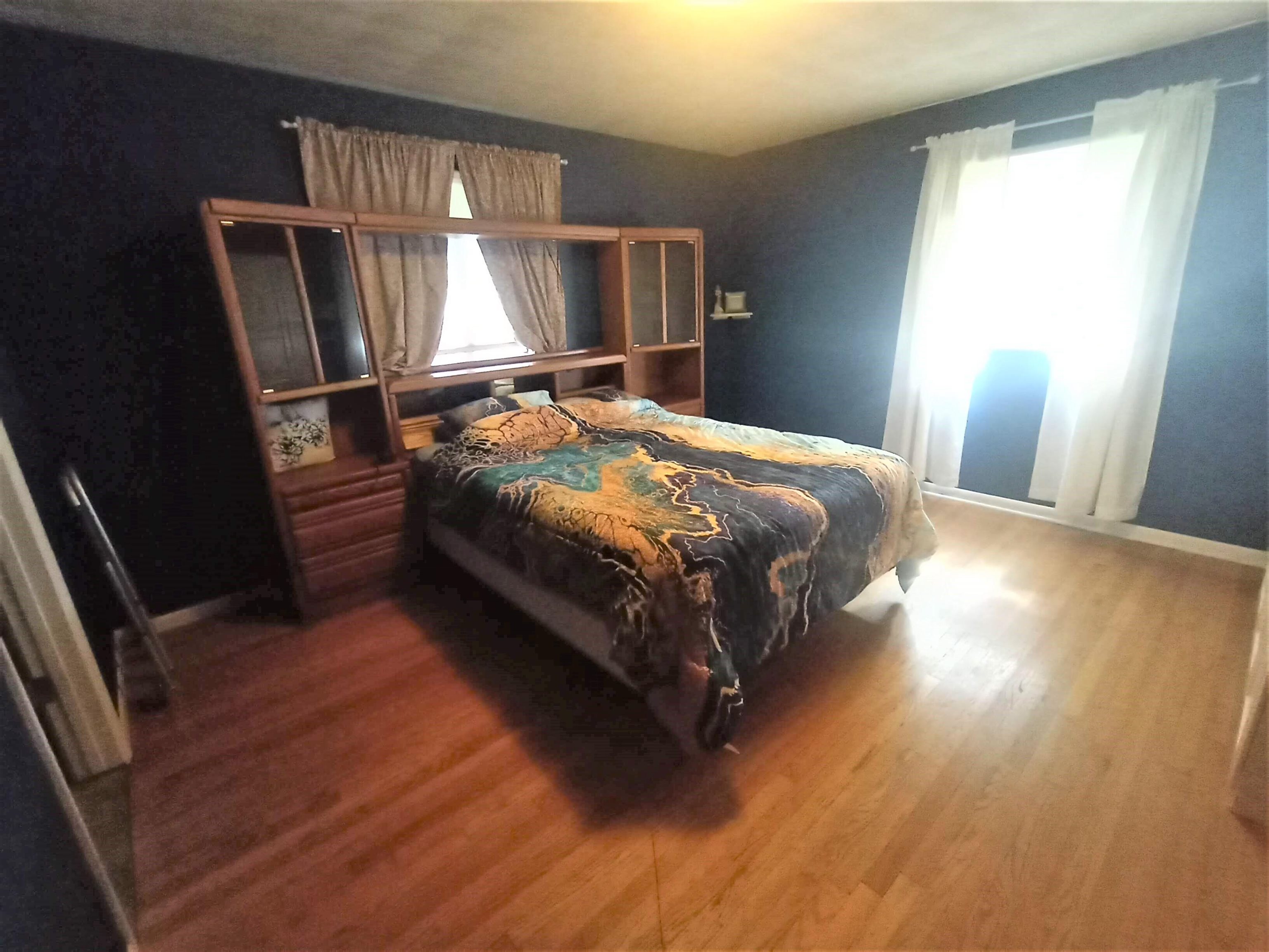 5242 Brookview Road Rockford, IL 61107 - Photo 19 of 44 a bedroom with a bed wooden floor and window