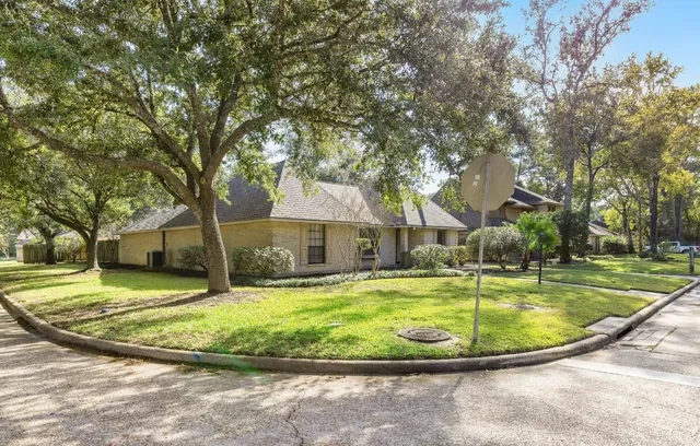 a view of a white house with a swimming pool