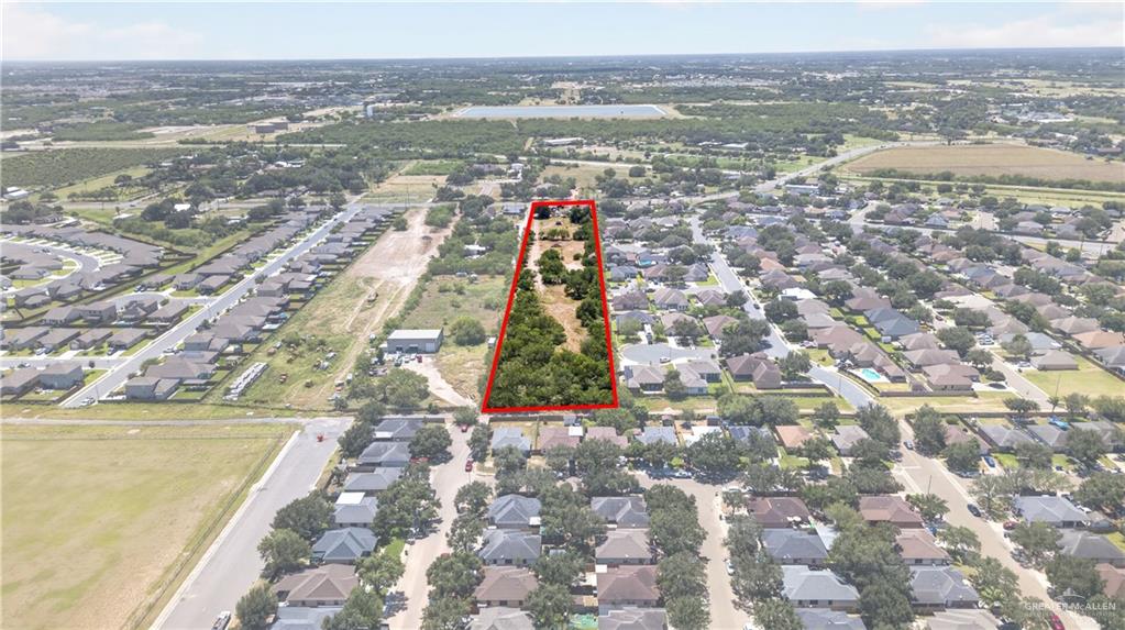 8900 North Ware Road McAllen, TX 78504 - Photo 7 of 13 Expansive lot outlined in red, featuring significant tree coverage and clear development potential