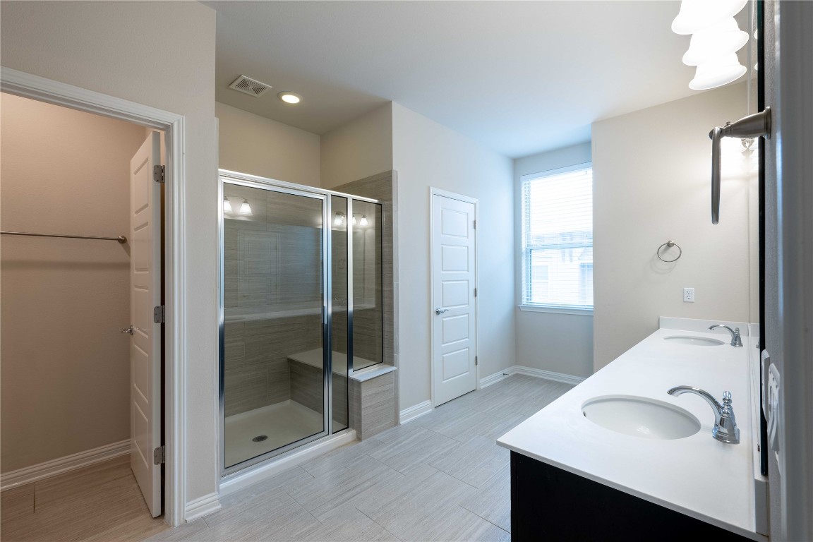 13800 Lyndhurst Street, Unit 281 Austin, TX 78717 - Photo 24 of 33 Master bathroom featuring double vanity and a shower stall