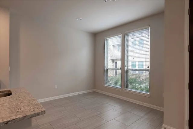 a large kitchen with stainless steel appliances granite countertop a refrigerator a sink a stove and oven