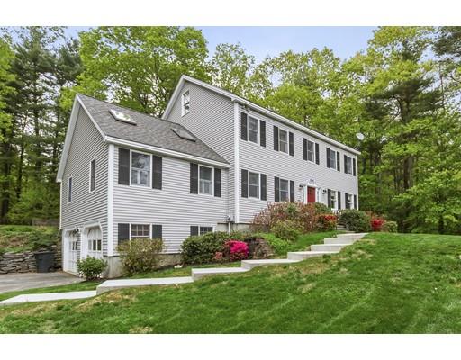 13 Oak Hill Street Pepperell, MA 01463 - Photo 1 of 30 a front view of a house with a yard and potted plants