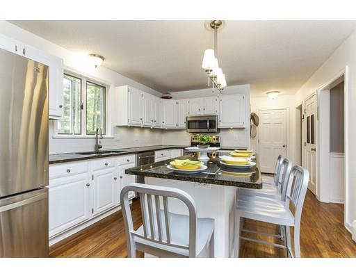 13 Oak Hill Street Pepperell, MA 01463 - Photo 12 of 30 a kitchen with kitchen island a stove a refrigerator a sink a dining table and chairs