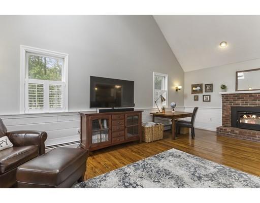 13 Oak Hill Street Pepperell, MA 01463 - Photo 14 of 30 a living room with furniture a flat screen tv and a fireplace