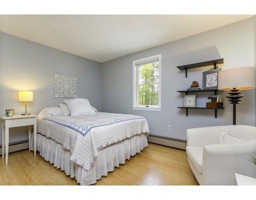 13 Oak Hill Street Pepperell, MA 01463 - Photo 21 of 30 a bedroom with a bed a table and chair