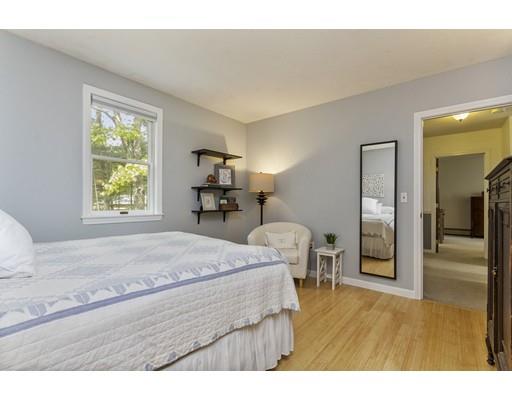 13 Oak Hill Street Pepperell, MA 01463 - Photo 22 of 30 a bedroom with a bed and wooden floor