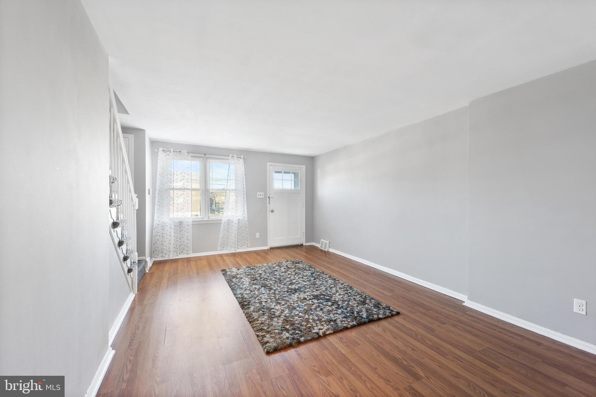 3006 Heather Road Folcroft, PA 19032 - Photo 5 of 25 an empty room with wooden floor and windows