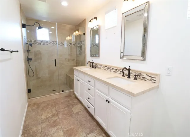 a bathroom with a shower sink and mirror