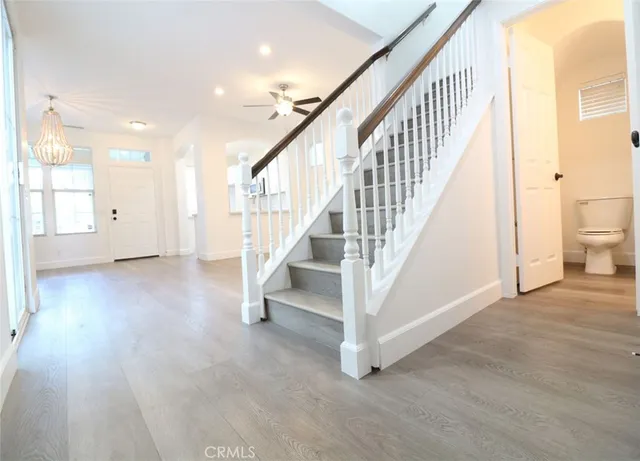 a view of entryway and hall with wooden floor