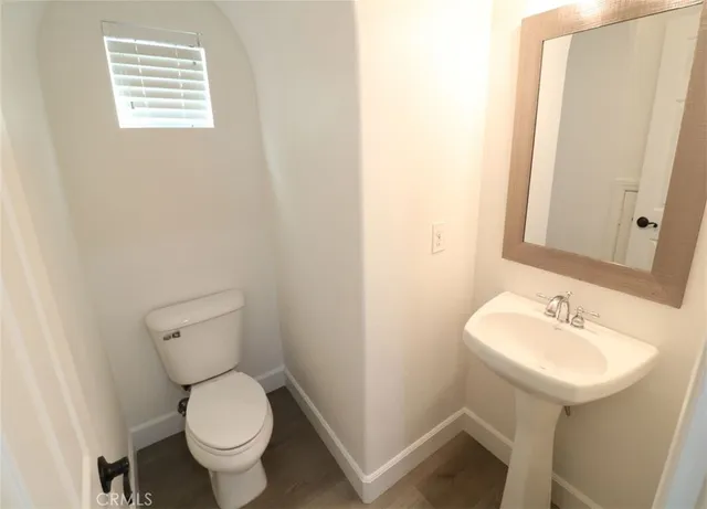 a bathroom with a sink toilet and a mirror