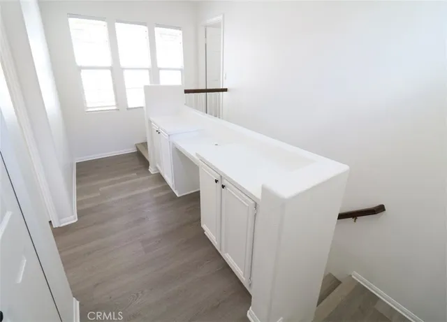 a hallway with stairs and a window