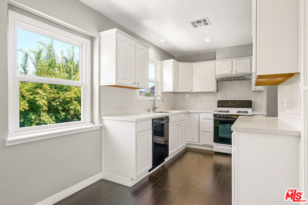 5343 Blanco Way Culver City, CA 90230 - Photo 11 of 30 a kitchen with a white stove top oven and white cabinets