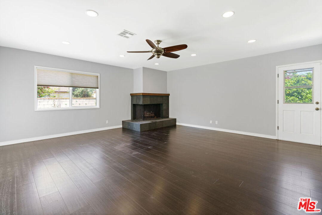 5343 Blanco Way Culver City, CA 90230 - Photo 18 of 30 an empty room with wooden floor ceiling fan and windows