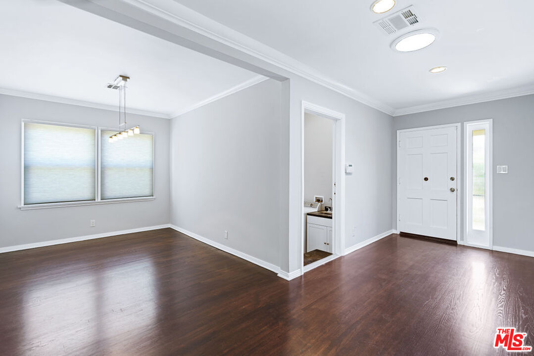 5343 Blanco Way Culver City, CA 90230 - Photo 9 of 30 an empty room with wooden floor chandelier and windows