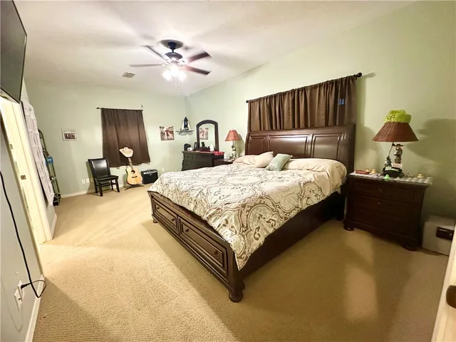 a bedroom with a bed and dresser with mirror