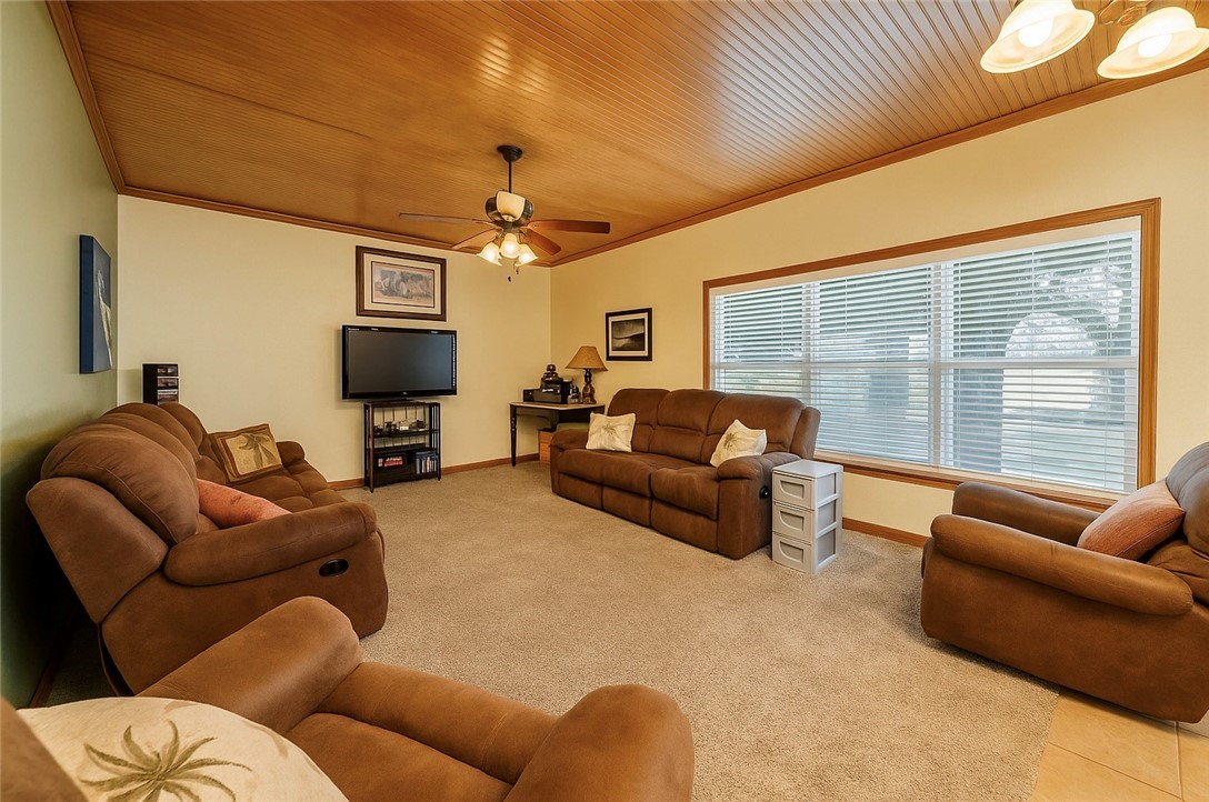 39 Front Street Rockport, TX 78382 - Photo 15 of 38 a living room with furniture a large window and a flat screen tv