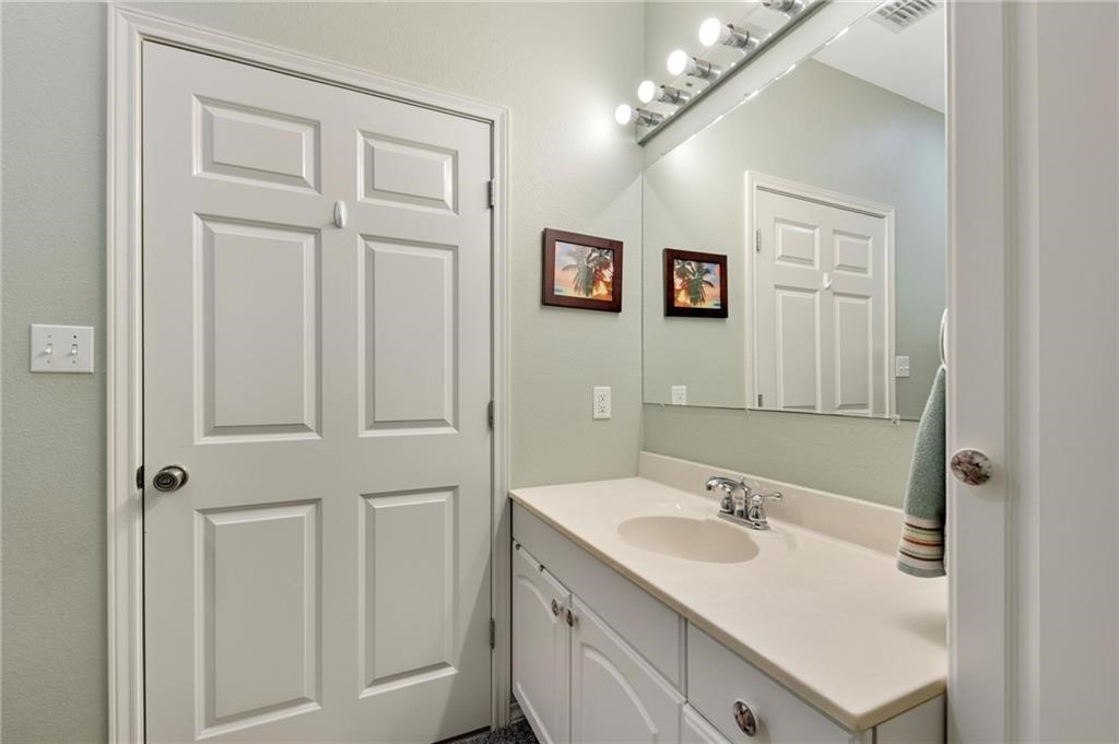 39 Front Street Rockport, TX 78382 - Photo 23 of 38 a bathroom with a sink double vanity and a mirror