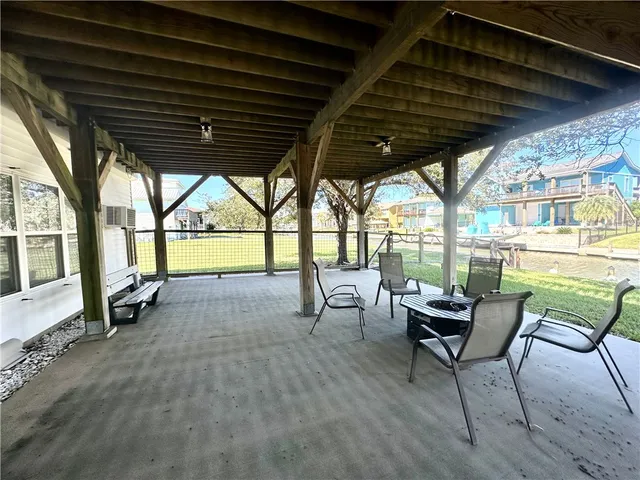 a view of a porch with furniture and a yard