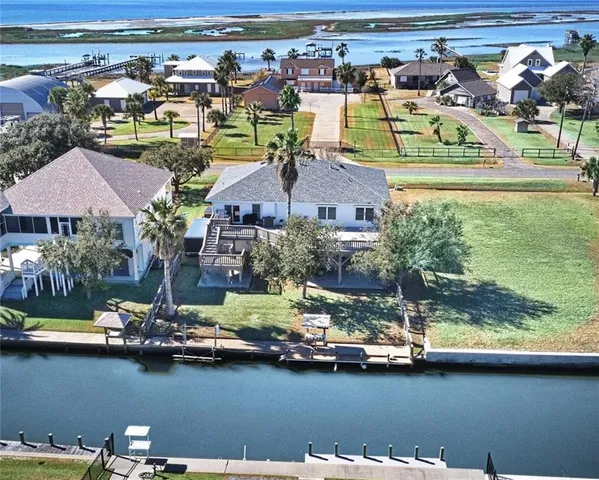 an aerial view of residential houses with outdoor space and swimming pool
