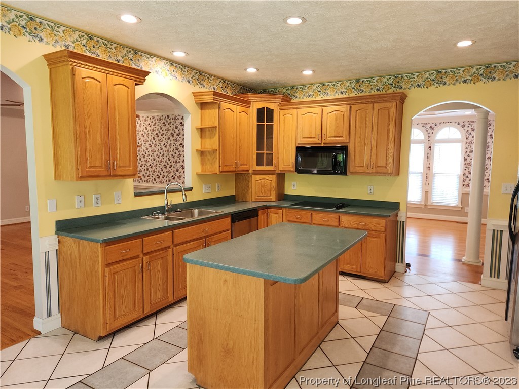 2730 Chimney Point Linden, NC 28356 - Photo 6 of 30 a kitchen with stainless steel appliances granite countertop a sink and a stove top oven
