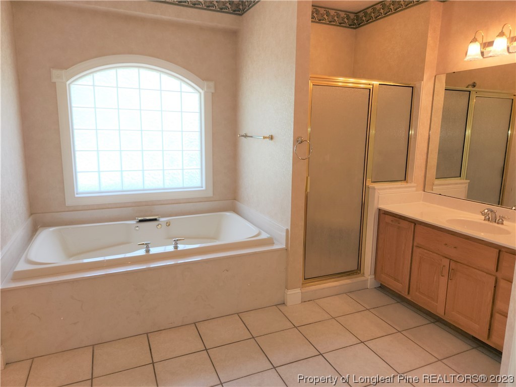 2730 Chimney Point Linden, NC 28356 - Photo 10 of 30 a bathroom with a tub sink and mirror