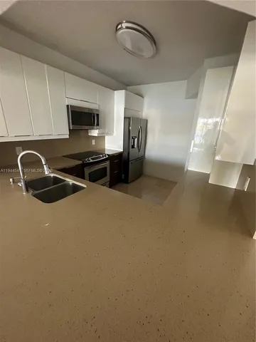 a view of a double sink and front door