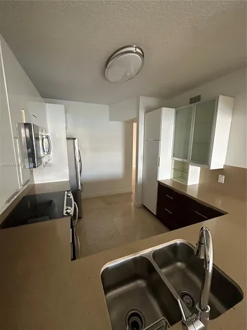 a kitchen with a sink and cabinets
