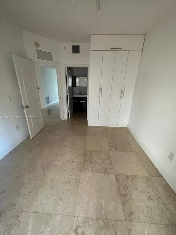 an empty room with a empty space and windows