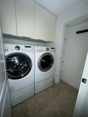 a view of an empty room with wooden floor and windows