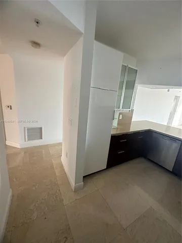 a kitchen with stainless steel appliances a refrigerator and a sink