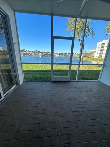 an empty room with sliding door and wooden floor