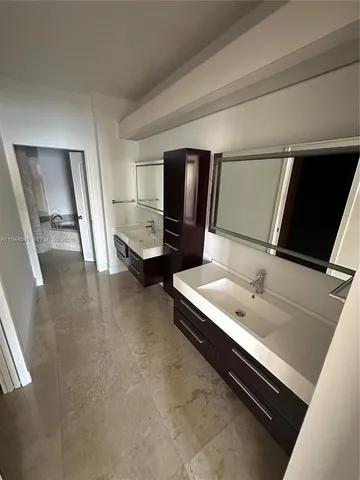 a view of walk in closet with clothes