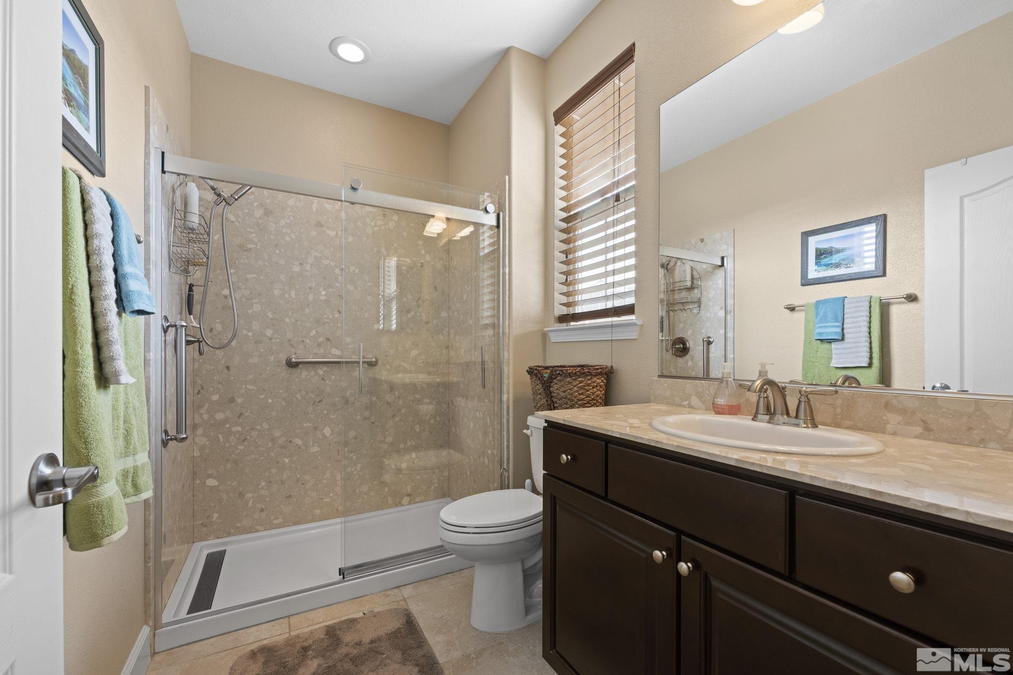 10674 Washington Reno, NV 89521 - Photo 29 of 40 a bathroom with a sink a toilet and shower
