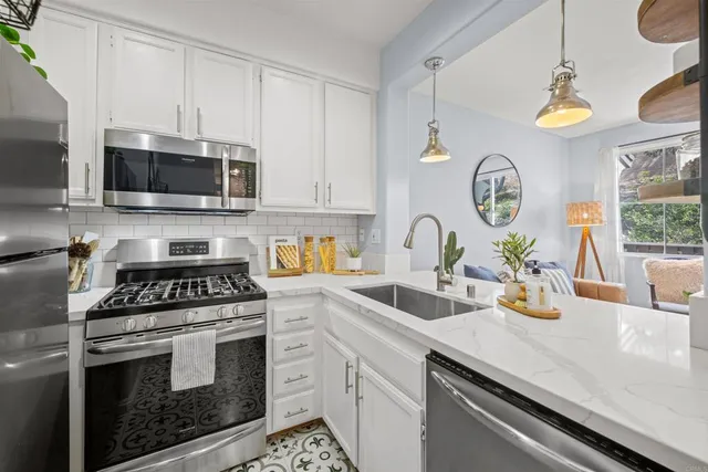 a front view of a dining room with furniture to ceiling window and potted plants on the table