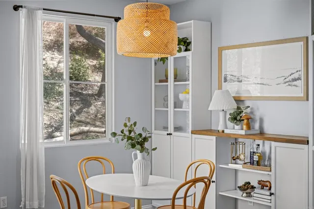 a dining room with furniture window and wooden floor