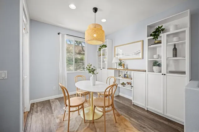 a view of a dining room with furniture and chandelier