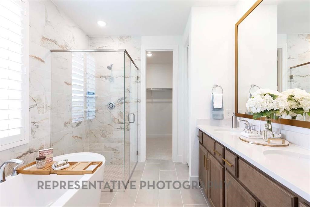 2140 Nerello Way Rockwall, TX 75032 - Photo 16 of 36 a bathroom with a double vanity sink and a mirror
